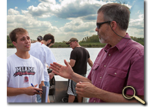 Professor and student discussing field ecology on boat in Acton Lake photo