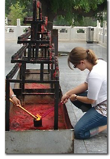 Christina lighting incense in Tianjin, China, photo