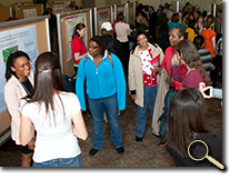 Students and faculty at Undergraduate Research Forum poster presentation photo